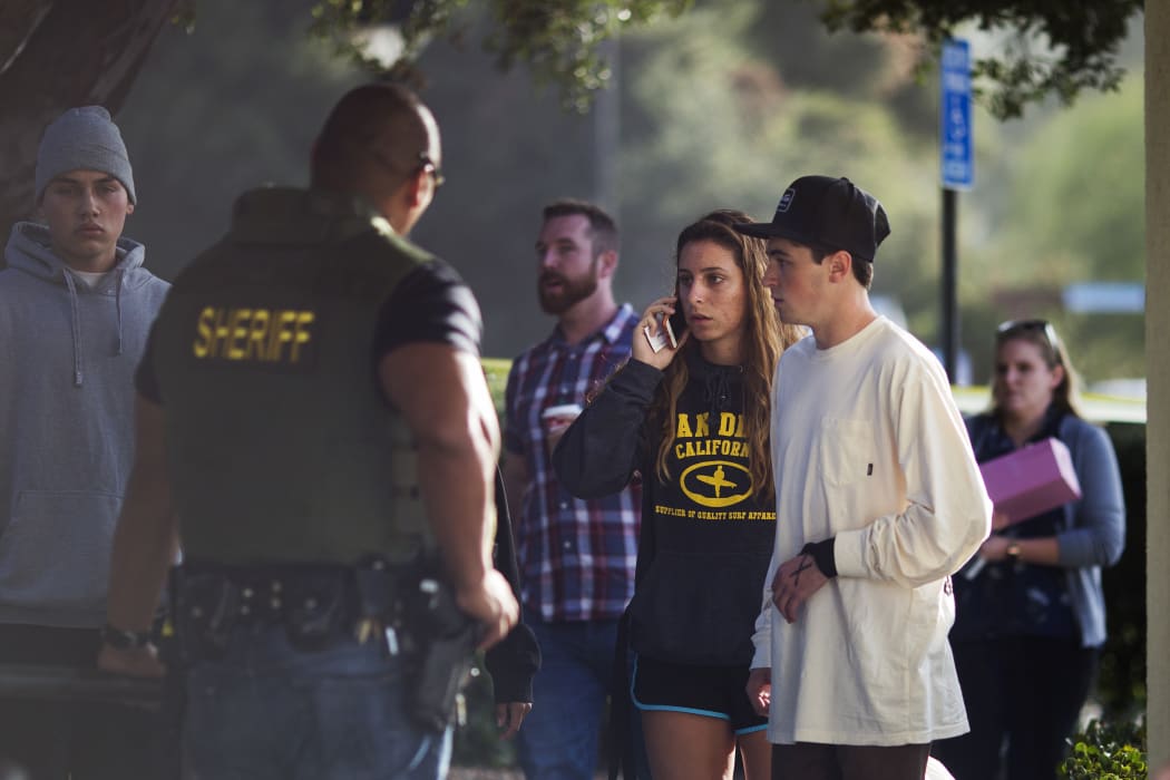 People arrive to a family assistance and reunification center following a mass shooting at the Borderline Bar and Grill.