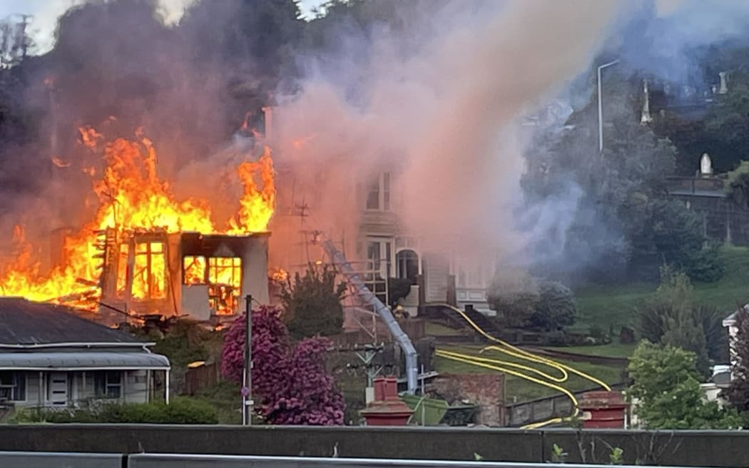 Six fire appliances and a command unit are fighting the blaze on Phillips Street in the suburb of Kensington in Dunedin on 27 October 2023.