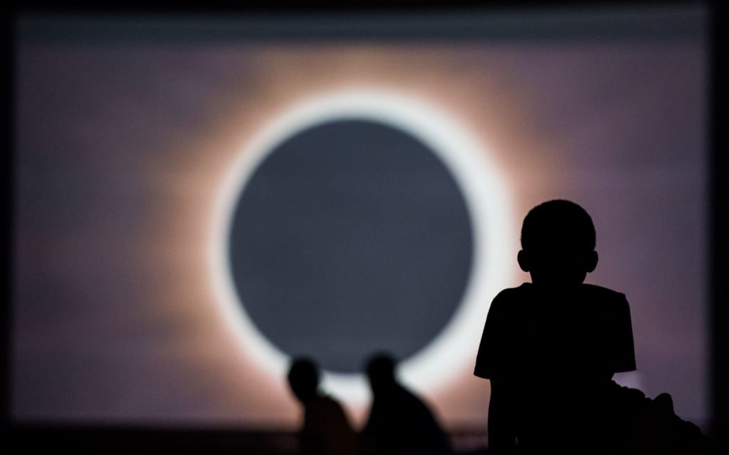 Children watch a presentation about the eclipse during a drive-in movie at the Historic Columbia Speedway in South Carolina. Columbia is one of the prime destinations for viewing Monday's solar eclipse and NASA expects clear weather would bring over a million visitors to the state.
