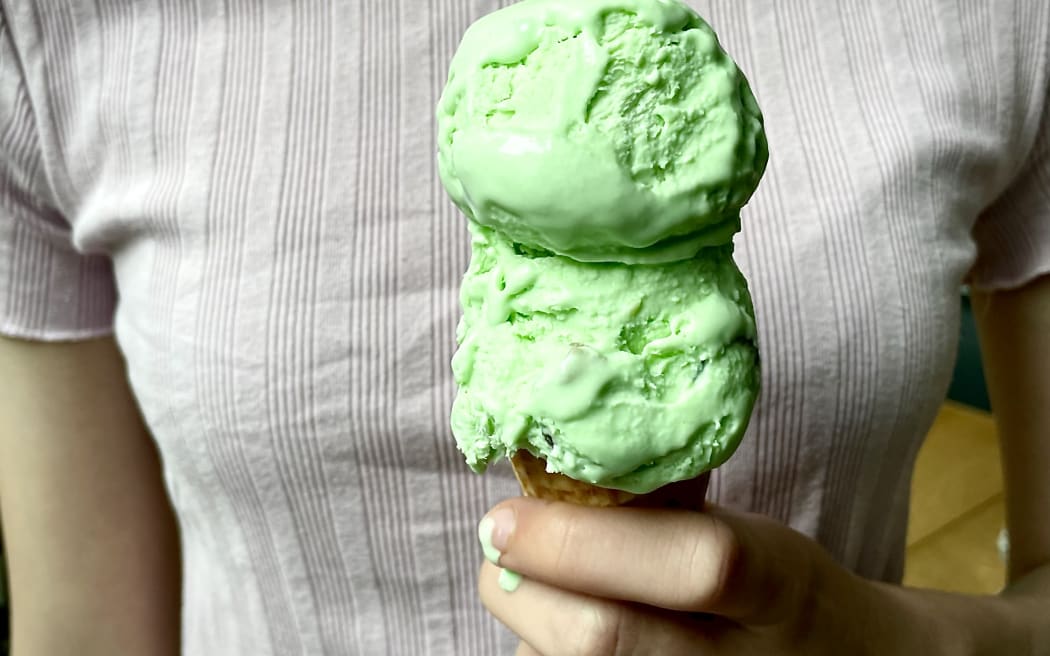 Homemade Goody Gumdrop Ice Cream - a close up of a hand holding a cone topped with two scoops