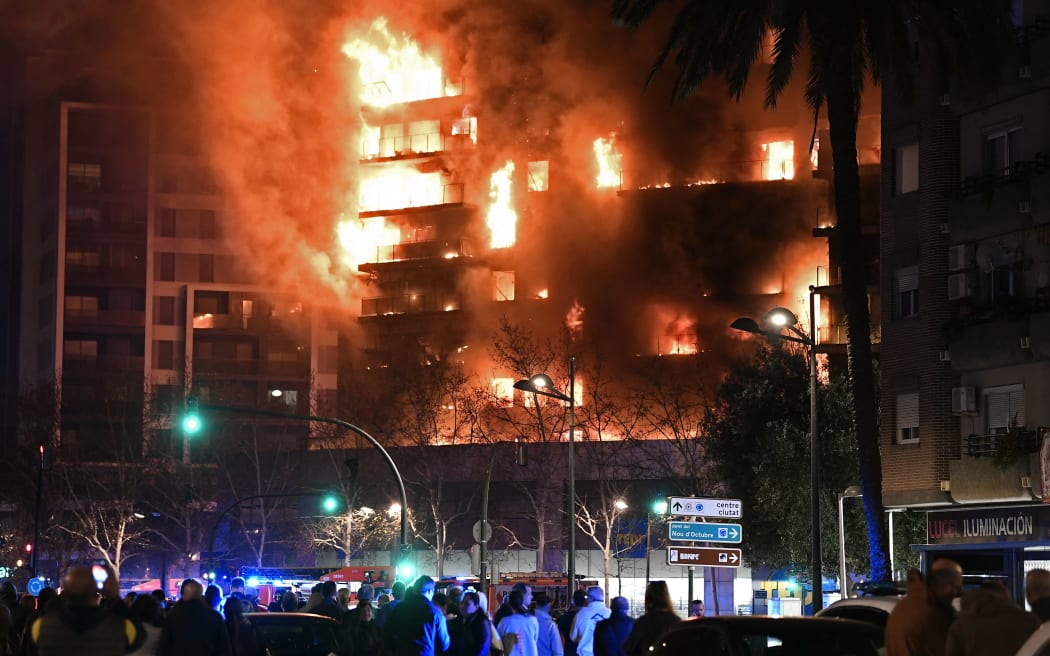 A huge fire rages through a multistorey residential block in Valencia on February 22, 2024. (Photo by Jose Jordan / AFP)