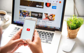 In a hand for man with social networking service Youtube on the screen IPhone6. YouTube is the popular online video sharing website.