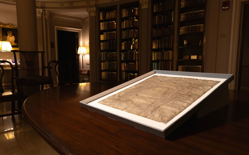 A rare copy of Magna Carta from 1300 sits in a display case at Harvard Law School in Cambridge, Massachusetts on 15 April 2025.