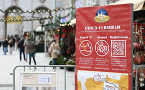 A sign displays Covid-19 health rules at a Christmas market in Salzburg, Austria.