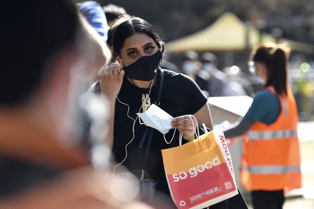 A woman stands waiting to get vaccinated in Sydney.