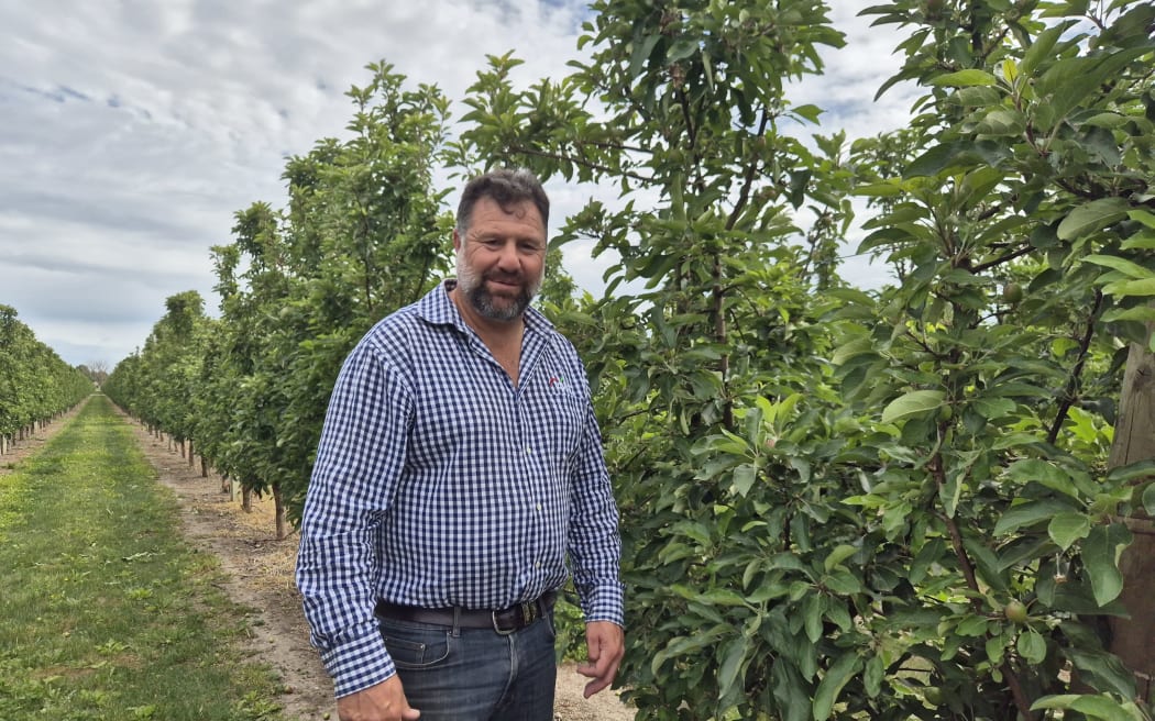 Cameron Taylor next to one of the company's new orchard blocks where they are growing a range of new apple varieties.