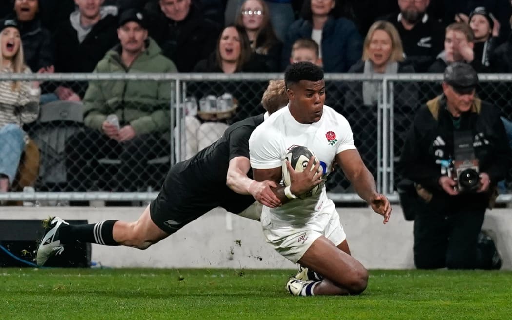 Immanuel Feyi-Waboso scores for England against the All Blacks at Dunedin.