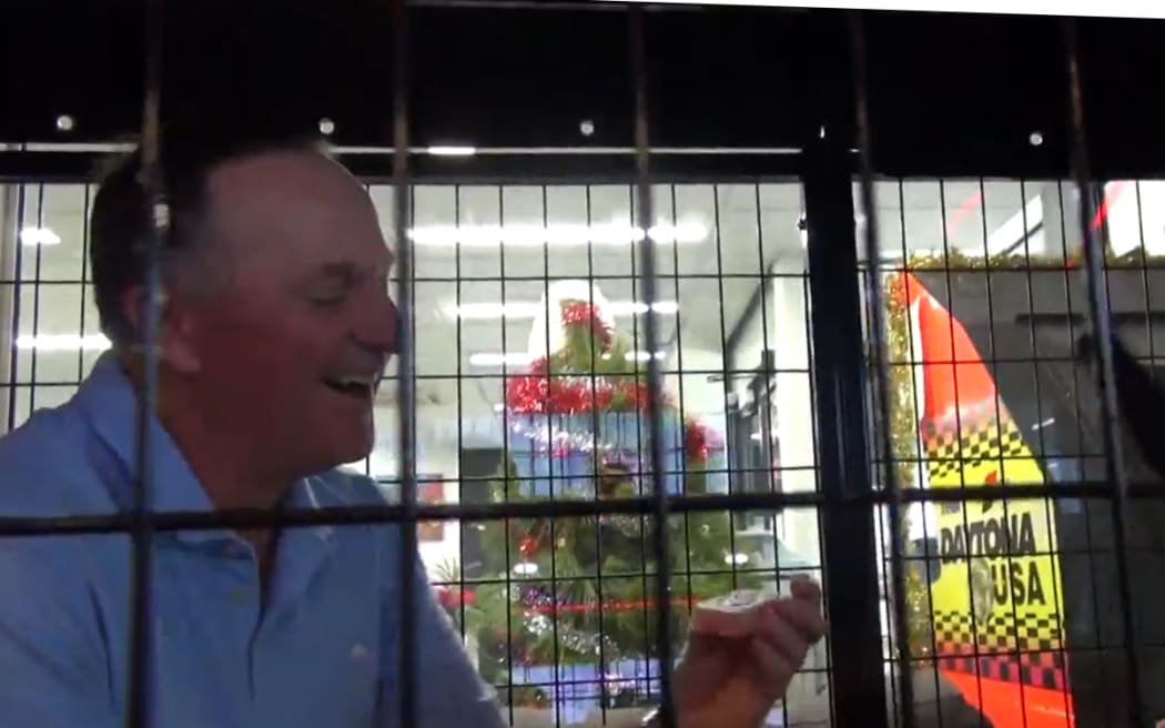 John Key climbed into a cage and was asked to pick up a bar of soap during an interview on The Rock.