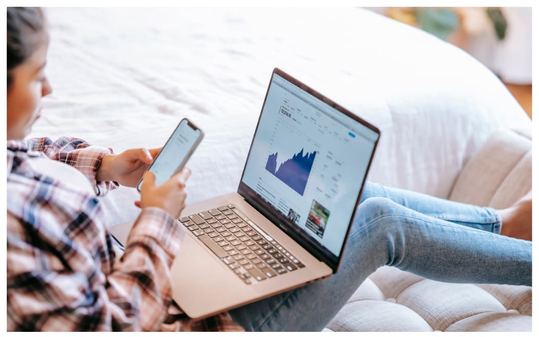Woman checking investments via laptop.