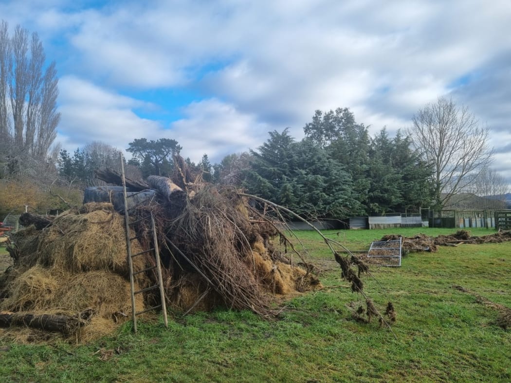 Debris left from the flooding, and a fence thrown across Gary Williams' paddock in Okuku, north Canterbury.