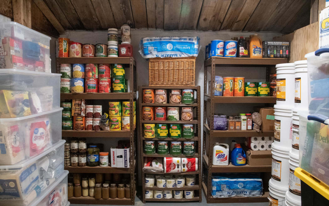 A storage room stacked with food is seen at Fortitude Ranch in Mathias, West Virginia, on March 13, 2020. The narrow, worn track in West Virginia, close to the foothills of the Appalachians, leads to a camp set back in the woods, where a group of US survivalists began preparing for the collapse of civilization long before the arrival of the new coronavirus that has brought so much of the world to a halt. The Fortitude Ranch's motto embraces both End Times and more normal times: "Prepare for the Worst... Enjoy the Present!" Members have up to two weeks each year to revel in this rural retreat, enjoying nature, hiking or trout fishing in the appropriately named Lost River. (Photo by NICHOLAS KAMM / AFP)