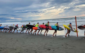 Competitors line up for a men's board race at the national surf life saving championships at New Brighton Beach, Christchurch on 9 March, 2023.