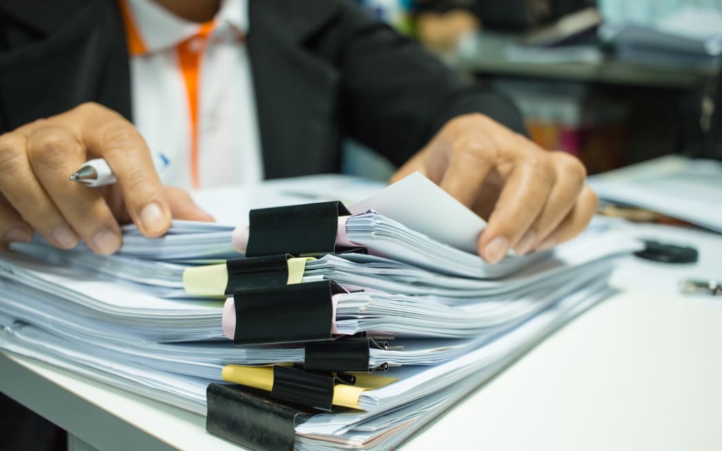 Stacks of documents in an office.