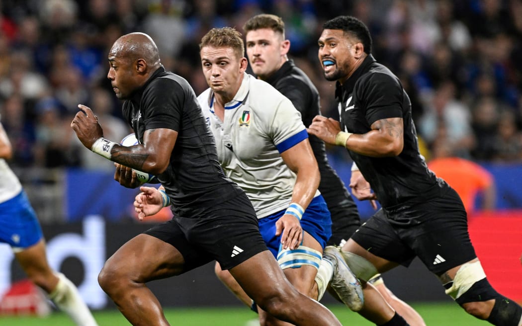 All Blacks winger Mark Telea makes a break against Italy.