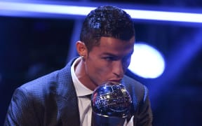 Real Madrid and Portugal forward Cristiano Ronaldo kisses the trophy after winning The Best FIFA Men's Player of 2017 Award.