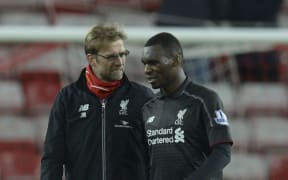 Liverpool's German manager Jurgen Klopp (L) talks with goalscorer Christian Benteke after the final whistle at Sunderland