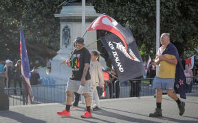 Protesters against Covid-19 vaccine mandates were carrying flags and signs.