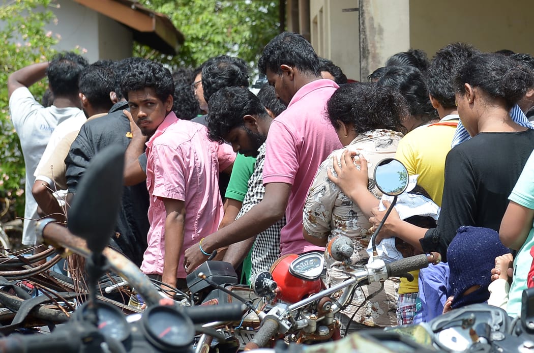 Asylum seekers sent back by Australia queue to enter the magistrate's court in Galle.