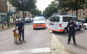 A picture taken on 17 June 2016 showing Belgian police officers standing guard in the district of Etterbeek, in Brussels.