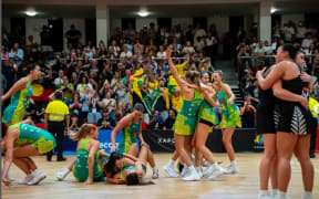 Australia celebrate winning the Netball World Youth Cup 2025, while the New Zealand players console each other.