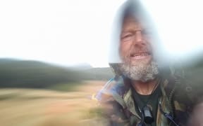 A portrait of Bruce Hopkins in heavy rain in Southland.