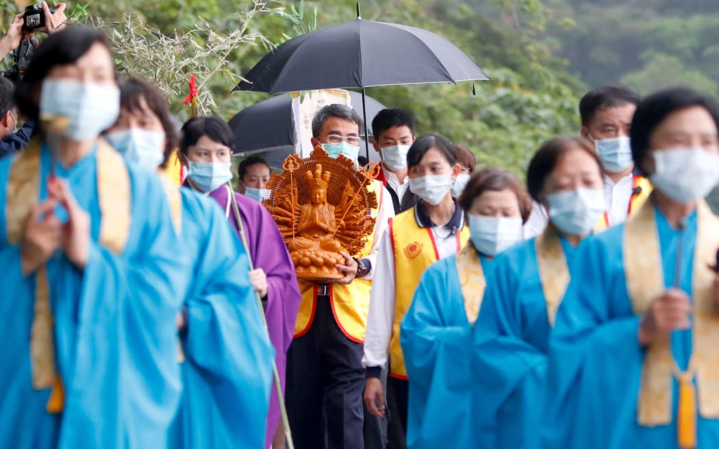 About a hundred people take part during a memorial ceremony mourning for the deaths of the train derailment, in Hualien, Taiwan, on April 4, 2021 killing at least 50 and injuring dozens which took place on 2 April.