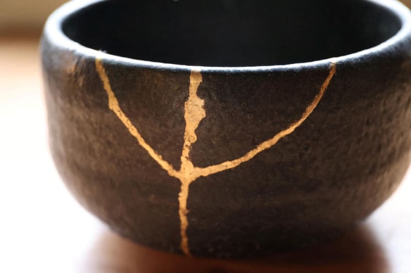 A picture shows a bowl mended with Kintsugi, Japanese traditional repair method of ceramics, in Tokyo on May 18, 2021. Broken potteries are glued with lacquer and finished with gold and other metal powders. There are some national treasures that were mended with Kintsugi, as the Kintsugi raises artistic quality. ( The Yomiuri Shimbun ) (Photo by Kentaro Aoyama / The Yomiuri Shimbun via AFP)