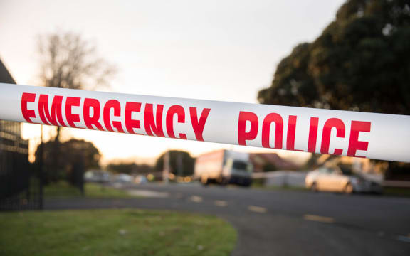 Police tape up at a cordon.
