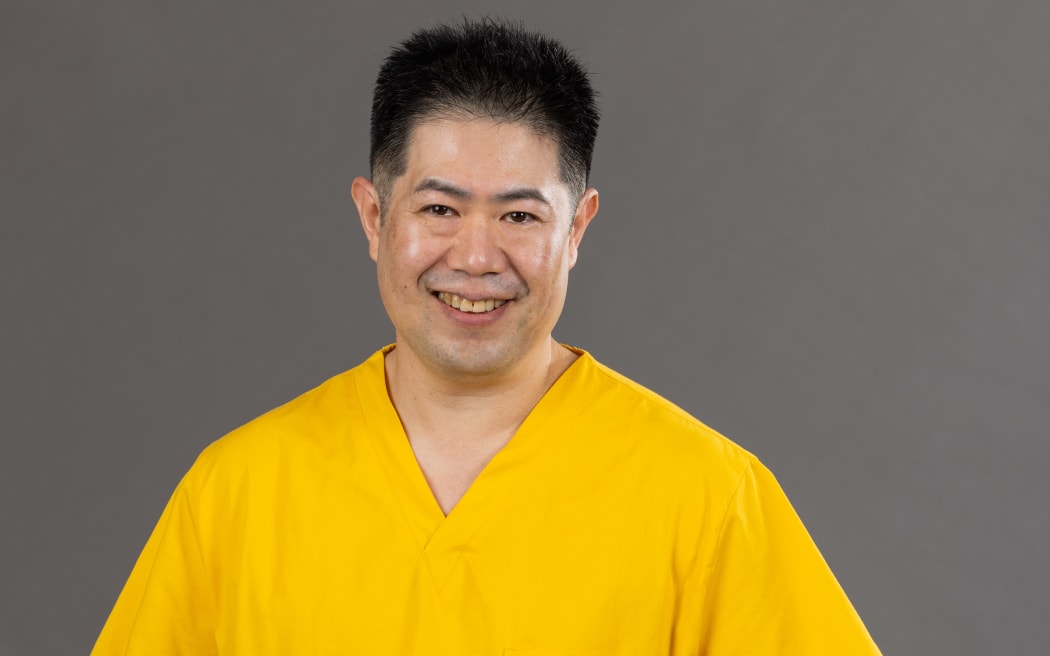 Dr James Jap in yellow scrubs