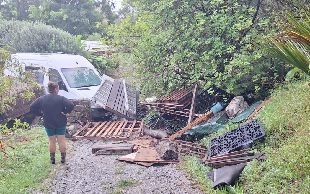 A flood-damaged van and debris piled up at the Cooks’ property by the 26 March storm.