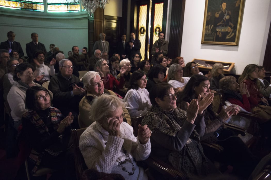 Relatives and victims of Argentine and Uruguayan military dictatorships react as they hear the sentence of Argentina's court in the trial on Operation Condor, at the Argentina's embassy in Montevideo on May 27, 2016.