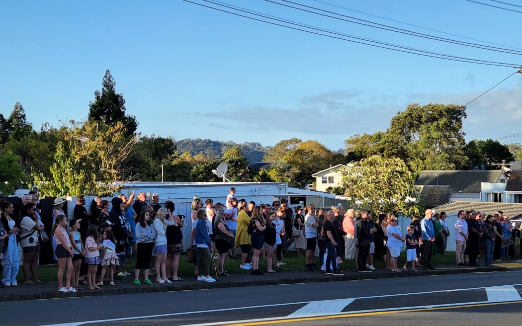 People walk to the Beach Haven site where Joshuah Tasi died to pay their respects.