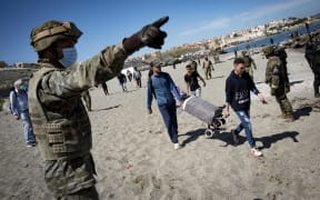 Spain deployed solders as migrants arrived entered the Spanish territory of Ceuta from Morocco, 18 May 2021.