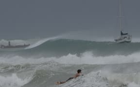 A surfer braves the waves in Carlisle Bay as Hurricane Beryl passes through Bridgetown, Barbados, July 1, 2024.