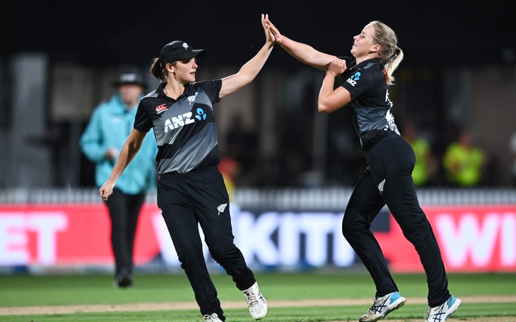 Amelia and Jess Kerr celebrate a wicket for the White Ferns.