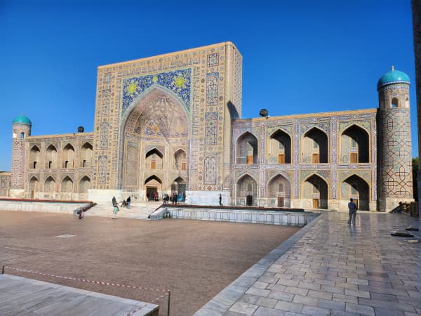The Registan, a plaza bordered by ornate, mosaic-covered religious schools dating to the 15th and 17th centuries in the Uzbekistan city of Samarkand, is lit up at night. For use with summer story only
