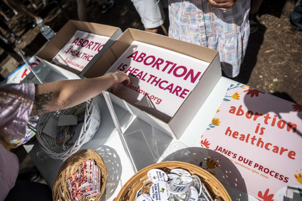 In this file photo attendees grab signs at a protest outside the Texas state capitol on May 29, 2021 in Austin, Texas.