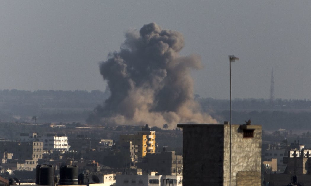 Smoke rises from buildings following an Israeli air strike on Gaza City.