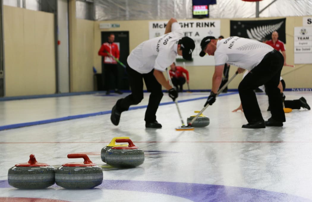Anton Hood (left) and Warren Dobson sweep ahead of a New Zealand stone