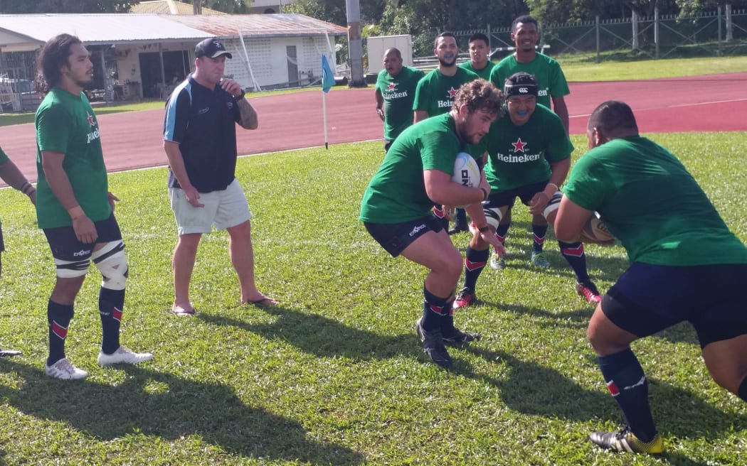 Former Hurricanes prop Tony Penn (2L) puts Guam players through their paces.