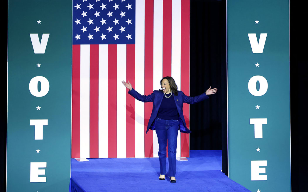 US Vice President and Democratic presidential nominee Kamala Harris walks on stage as she arrives for a campaign rally at Michigan State University's Jenison Field House in East Lansing, Michigan, on November 3, 2024. (Photo by JEFF KOWALSKY / AFP)