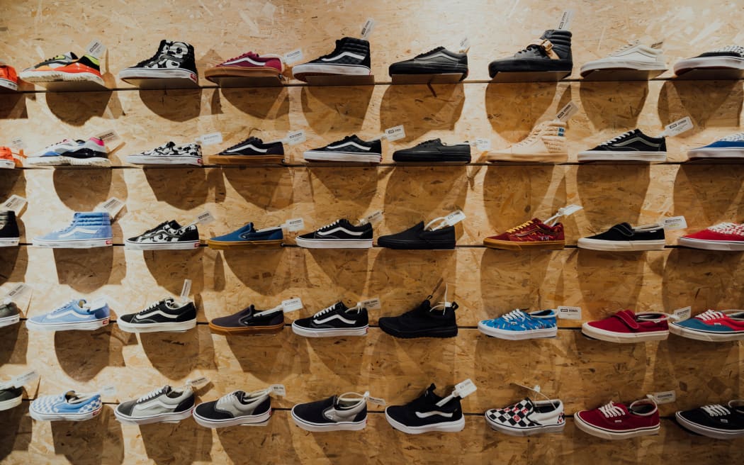 a row of sneakers in a shoe store