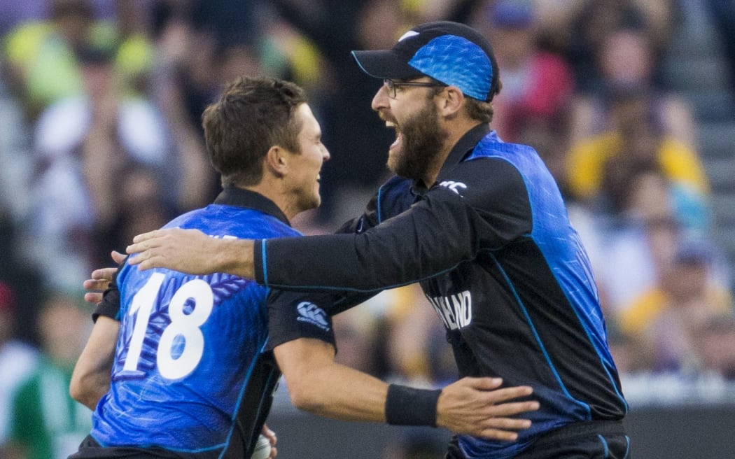 Trent Boult celebrates with Daniel Vettori after getting the wicket of Aaron Finch during the ICC Cricket World Cup Final match.