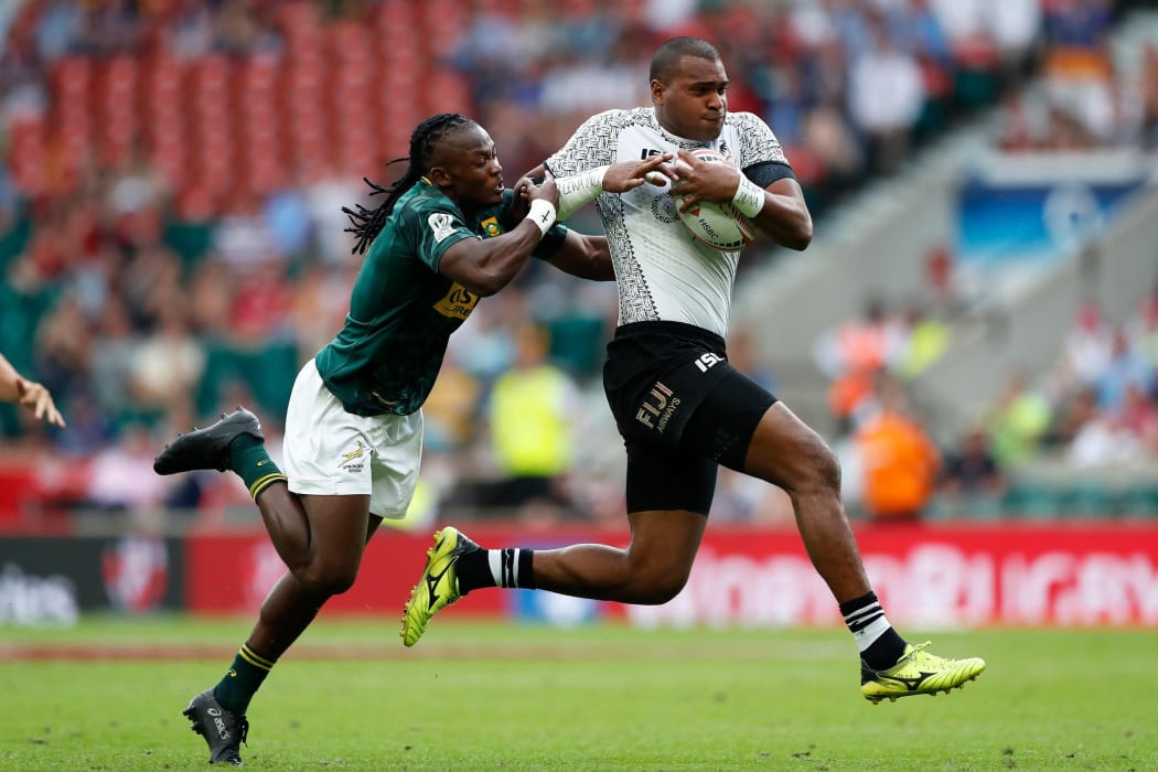 Fiji's Paula Dranisinukula drives through the tackle from South Africa's Seabelo Senatla during the London 7s final.