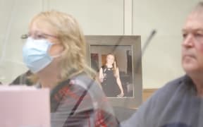 Carey Hume (left) at the inquest of her daughter Erica Hume (in framed picture) who died in a suspected suicide when she was a Palmerston North Hospital mental health ward patient.