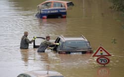 Soldiers of the German armed forces Bundeswehr search for flood victims in submerged vehicles on the federal highway B265 in Erftstadt.