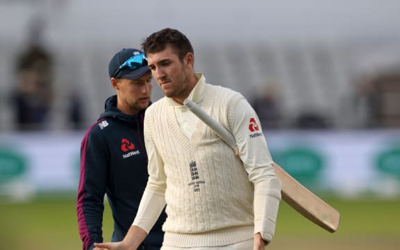 Captain Joe Root (left) commiserates with batsman Craig Overton after losing the 4th Ashes Test Match between England and Australia at Old Trafford, Manchester on 8th September 2019.