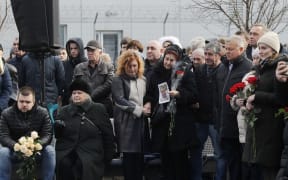 People pay tribute during a ceremony of a foundation stone for a future memorial and the square to memory the victims of the Ukraine International Airlines flight PS752 plane crash, at the Boryspil International Airport near Kyiv, Ukraine, on 17 February, 2020.