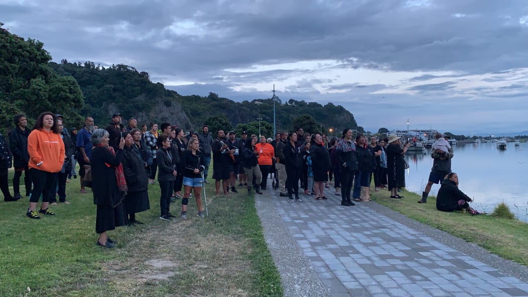 About 50 whānau, friends and members of the local community gather for a karakia at the cordon at the Whakatāne Boat Ramp.