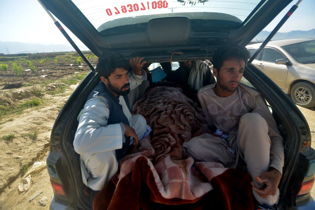 Dead bodies are taken away, a day after gunmen opened fire on worshippers at a mosque, in Charikar Parwan Province on 20 May 20, 2020. A police chief said at least 7 were killed and 12 wounded.
